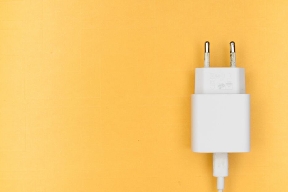 Phone charger on orange background